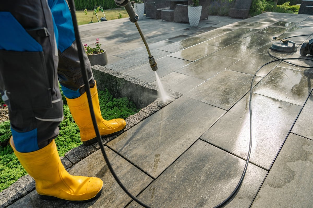 A sunny day pressure washing of a stone patio