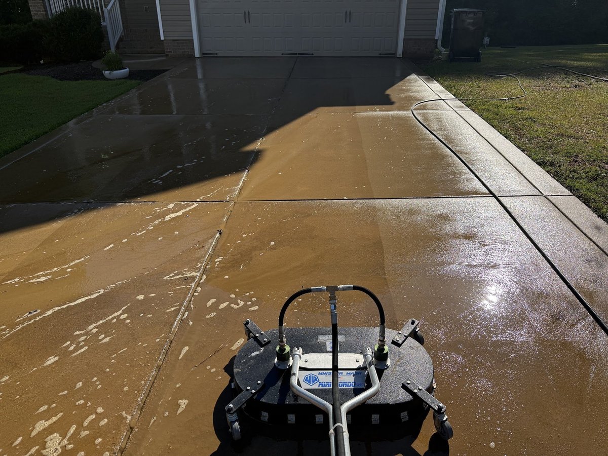 Surface cleaner pressure washing a concrete residential driveway